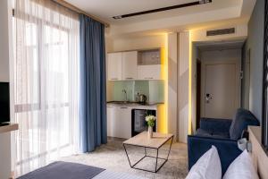 a room with a bed and a couch and a table at Rooftop Apart-Hotel in Yerevan