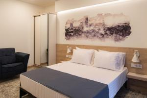 A bed or beds in a room at Rooftop Apart-Hotel