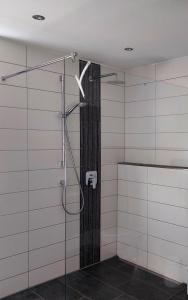 a bathroom with a shower with a glass door at Ferienhaus Rasch in Maierhöfen