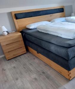 a bedroom with two beds and a night stand at Ferienhaus Rasch in Maierhöfen