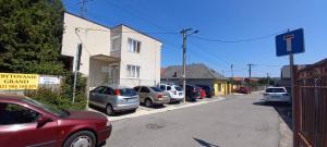 a row of cars parked on the side of a street at Grand House in Štúrovo