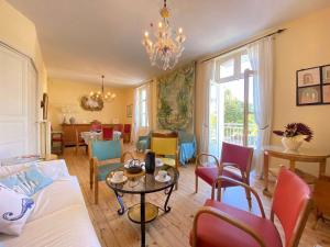 a living room with a chandelier and a table and chairs at Appartement La Baule, 5 pièces, 6 personnes - FR-1-245-71 in La Baule