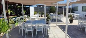 a table and chairs under an umbrella on a patio at Hotel Ruta Romana in Sagunto