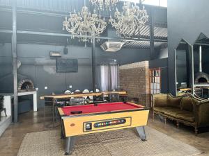 a ping pong table in a room with a ping pong ball at Conductor's Inn in Tsumeb +16 photos