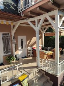 a patio with a white pergola on a house at Apartment Patricia in Siófok
