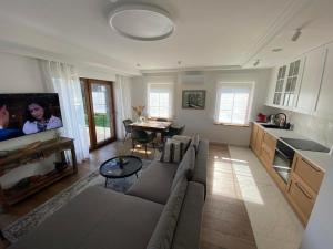 a living room with a couch and a table in it at Pape Apartament in Pape