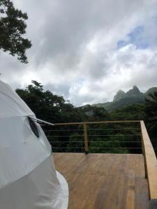 a white car parked on top of a wooden deck at Casa Luna Glamping in Sorá