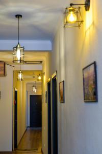a hallway with two lights on the wall and a hallway with a hallway at Chveni Qalaqi in Kutaisi