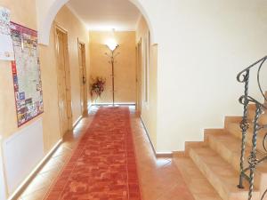 a hallway with a red tile floor and stairs at Willa Ewa in Poronin