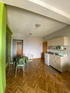 a kitchen and dining room with a table and chairs at Vila SiVa in Ohrid