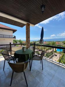 a patio with a table and chairs on a balcony at Vila SiVa in Ohrid