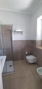 a bathroom with a shower and a toilet and a sink at B&B Tenuta San Michele in Capaccio-Paestum