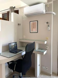 a desk with a laptop and a chair in a room at VillaGer in Kalamata