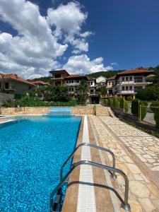 a swimming pool with blue water in front of some houses at Vila SiVa in Ohrid