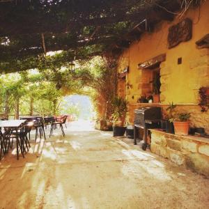 a patio with tables and chairs in a building at LA MANDUCA in Teruel