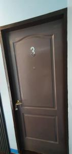 Una porta marrone con il numero tre sopra. di West Atlantic Inn a Concepcion