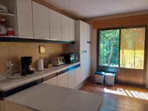 a kitchen with a counter and a window in it at Puente Canto de Gredos in Arenas de San Pedro