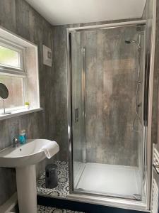 a bathroom with a shower and a sink at Balfour B - Fully refurbished 2 bedrooms Ideal for Contractors and Families Free wifi Free Parking Ground Floor in Gateshead +8 photos