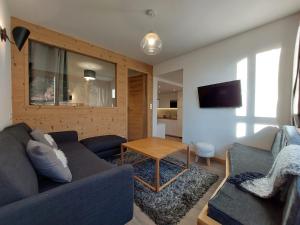 a living room with a couch and a table at Appartement Les Arcs 1800, 3 pièces, 7 personnes - FR-1-346-313 in Arc 1800