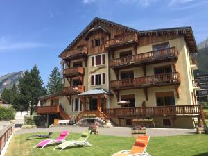 a large building with lawn chairs in front of it at Montana 3 in Pralognan-la-Vanoise