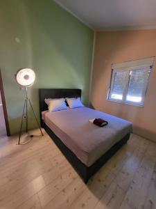 ein Schlafzimmer mit einem Bett und einer Lampe in der Unterkunft Happy house in Split