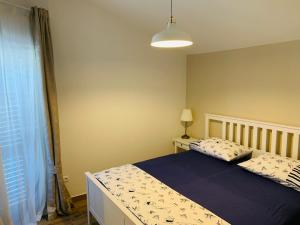 a bedroom with a bed with a blue blanket at Apartment Murvica in Pag
