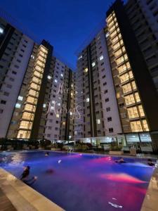 a large pool of water in front of tall buildings at The Marys Place-Cozy&Modern Fully Furnished StudioType Condo at MesaVerte Residences in Cagayan de Oro