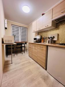 a kitchen with a table and a dining room at Apart Rooms City Centre in Warsaw