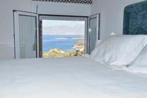 a bedroom with a bed with a view of the ocean at Villa Michelangelo in Agios Nikolaos