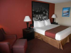 A bed or beds in a room at AmeriStay Inn St Joseph