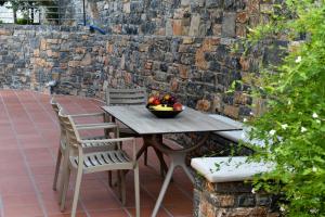 a table with a bowl of fruit on a patio at Villa Michelangelo in Agios Nikolaos