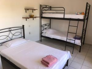 a bedroom with two bunk beds and a pink towel at Παραθαλάσσια κατοικία στην παραλία Κατακόλου in Pýrgos
