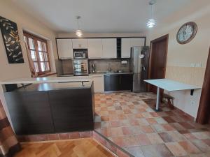 a kitchen with stainless steel appliances and a table at Luxury Home Cetinje in Cetinje +15 photos
