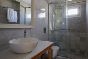 A bathroom at Sea Breeze Santorini Beach Resort, Curio By Hilton