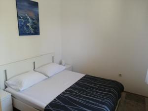 - un lit dans une chambre avec une photo sur le mur dans l'établissement House B - with spacious terrace and beautiful view, à Omiš