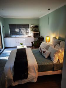 a bedroom with a large bed in a room at Calla—Cottage in Ballito