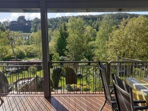 a balcony with chairs and a view of a garden at Haus WoogArt in Dahn