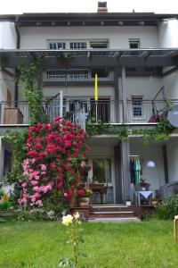 a building with pink flowers in front of it at Haus WoogArt in Dahn +23 photos