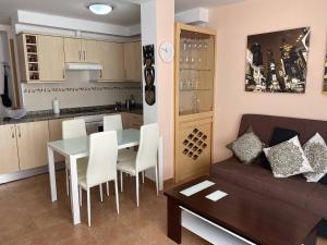 a living room and kitchen with a table and a couch at ALE´S HOUSE in Arrecife