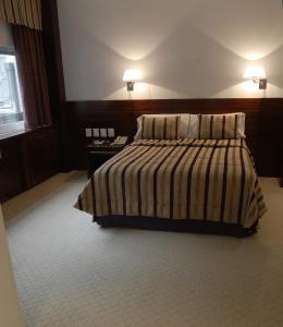 Postel nebo postele na pokoji v ubytování Bisonte Palace Hotel