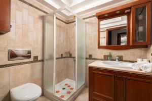 リンドスにあるLindos Luxury Belfry Apartmentのシャワー、トイレ、洗面台を備えたバスルーム