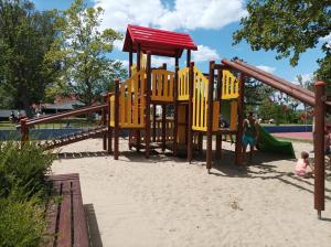 a playground in a park with a slide at Vivienne Apartment in Zamárdi