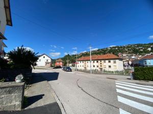 an empty street in a residential neighborhood with houses at Chez Minouche in La Bresse