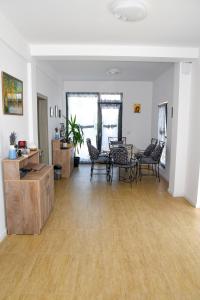 an empty living room with chairs and a table at Vila Siena in Sulina