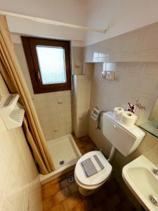 a small bathroom with a toilet and a sink at Pansion Giannis Perris in Kokkari