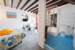 a bedroom with a bed and a bathroom at CASA RURAL GA7COLORES only adult in Montaña Blanca