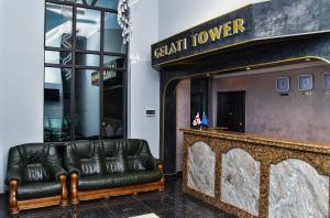 a lobby with a leather couch in front of a store at Gelati Tower in Gelat'i