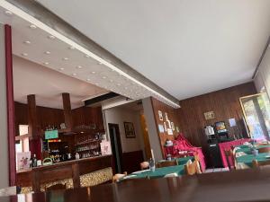 a dining room with tables and chairs and a mirror at Hotel Primavera in Desenzano del Garda