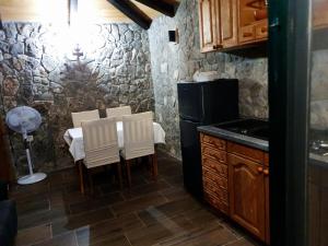 a kitchen with a table and chairs and a refrigerator at Robinson in Tisno +12 photos