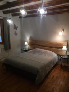 a bedroom with a large bed with lights on it at Gite Rammelstein in Ribeauvillé